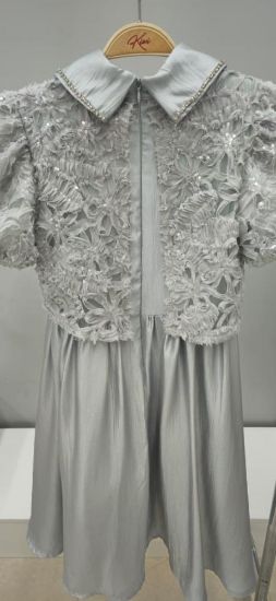 صورة فستان سماوي أنيق مزين بالتل على الصدر